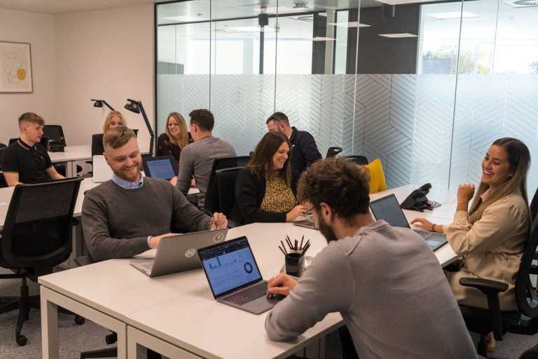 The Invotra Team working together in the office