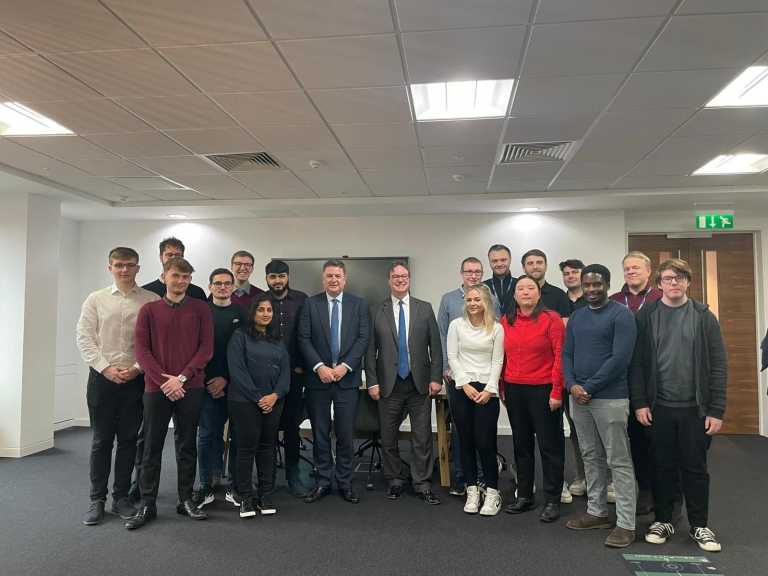 Secreatry of State, Rt Hon Mel Stride and Jonathan Lord MP in the Woking Office of Invotra, posing for a photo with Invotra staff